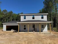 Charming two-story home featuring a welcoming front porch and attached two-car garage at 337 Green Pines Estates Dr, Kenly, NC 27542