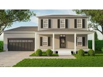 Charming two-story home featuring a covered front porch, a two car garage and manicured landscaping at 337 Green Pines Estates Dr, Kenly, NC 27542