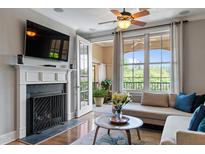 Inviting living room with fireplace, hardwood floors, and french doors to the balcony at 340 Allister Dr # 201, Raleigh, NC 27609