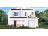 Charming two-story home featuring a white facade, brick accents, an attached garage, and manicured landscaping at 3604 Sorda Ct, Raleigh, NC 27610