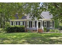 Charming home featuring mature landscaping, a well-manicured lawn, and a welcoming entrance at 413 Redpath Dr, Garner, NC 27529