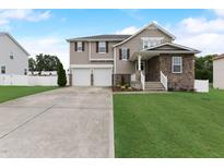 Charming two-story home featuring a two-car garage, stone accents, and a well-maintained front lawn at 4613 Jersey Pine Dr, Rolesville, NC 27571