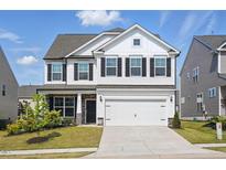 Charming two-story home with white siding, black shutters, and a two-car garage at 521 Glenwyck Ct, Fuquay Varina, NC 27526