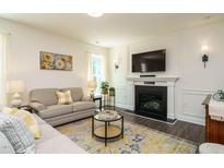 Inviting living room with a cozy fireplace, comfortable seating, and stylish decor at 555 Whitley Ridge Dr, Clayton, NC 27527