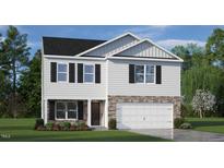 Charming two-story home with stone accents, a two-car garage, and manicured lawn at 5913 Sodium St, Raleigh, NC 27610