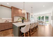 Bright, spacious kitchen features a large island with marble countertops and seating for four at 909 N Gregson St, Durham, NC 27701