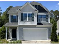 Charming two-story home featuring an attached two-car garage and well-maintained landscaping at 105 Blue Bay Ln, Cameron, NC 28326