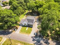 Charming single-story home with mature trees and a well-maintained yard and a spacious lot at 105 N 11Th St, Erwin, NC 28339
