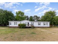 Charming single-story home with a well-maintained lawn and a cozy front porch at 168 Hoss Ridge Ln, Dunn, NC 28334