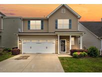 Charming two-story home with a well-manicured lawn and a two-car garage, perfect for families at 1839 Huntley Way, Burlington, NC 27215