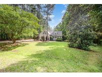 Charming home featuring a spacious lawn with mature trees and manicured landscaping at 25 Williamston Ridge Dr, Youngsville, NC 27596