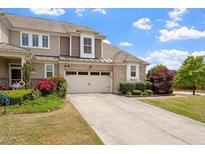 Charming two-story home boasts a well-manicured lawn and inviting curb appeal with blooming flowers at 2737 Casper Creek Ln, Raleigh, NC 27616