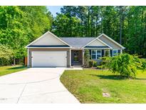 Charming single-story home with a two-car garage and landscaped front yard at 33 Carrington Cir, Angier, NC 27501