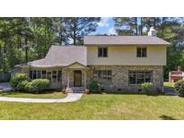 Charming two-story home with a stone facade and well-manicured front lawn at 409 W Holding St, Smithfield, NC 27577