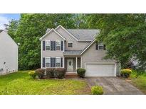 Charming two-story home featuring gray siding, a manicured lawn, and an attached two-car garage at 468 Hay River St, Garner, NC 27529