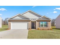 Charming brick home with an attached garage, manicured lawn, and lovely landscaping at 505 Lochalsh Dr, Gibsonville, NC 27249