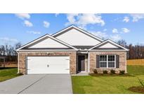 Charming single-story brick home with a two-car garage and well-maintained front lawn at 517 Lochalsh Dr, Gibsonville, NC 27249