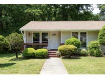 Charming home showcasing a well-manicured lawn, mature trees, and a welcoming front porch at 103 Westview Dr # Apt K, Carrboro, NC 27510