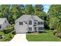 Charming two-story home featuring a well-manicured lawn, attached garage, and traditional architectural details at 11 Smoketree Ct, Durham, NC 27712