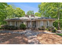 Charming one-story home with stone pathway, dormer windows, and lush landscaping at 11470 Club Dr, Chapel Hill, NC 27517