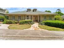 Inviting front exterior showcasing a charming one-story home with stone walkway and lush landscaping at 11475 Club Dr, Chapel Hill, NC 27517