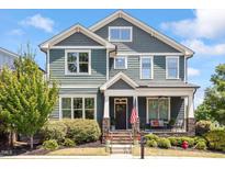 Charming two-story home with a covered front porch, stone accents, and a well-manicured lawn at 12 Beacon Ridge Blvd, Chapel Hill, NC 27516