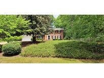 Beautiful two-story brick home featuring lush landscaping and a charming front entrance at 1274 Candlewood Dr, Elon, NC 27244