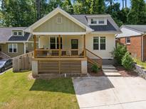 Charming bungalow with a covered front porch, wooden deck, and well-maintained lawn at 2003 Wa Wa Ave, Durham, NC 27707