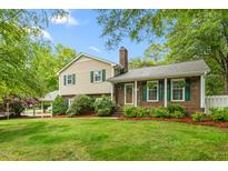 Charming two-story home featuring a brick facade, green shutters, and a well-manicured lawn at 204 Random Ln, Burlington, NC 27215