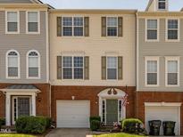 Charming townhome featuring a brick facade, attached garage, and well-maintained front yard at 216 Ruby Walk Dr, Morrisville, NC 27560