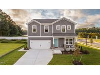Charming two-story home featuring a light blue front door and manicured lawn at 238 Oak Meadow Ln, Angier, NC 27501
