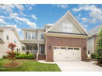 Charming two-story home with a brick-and-siding facade, well-manicured lawn, and a two-car garage at 2728 Cameron Pond Dr, Cary, NC 27519