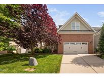 Charming brick home with a well-manicured lawn and a two-car garage at 2728 Cameron Pond Dr, Cary, NC 27519