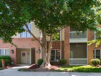 Charming condo building with brick facade, outdoor spaces, and mature trees at 412 Waterford Lake Dr, Cary, NC 27519