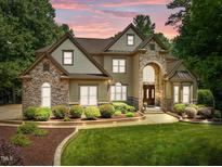 Stunning two-story home featuring stone accents, manicured landscaping, and a grand entrance, perfect for curb appeal at 901 Edgewater Dr, Garner, NC 27529