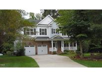 Charming two-story home with brick accents, a covered porch, and an attached two-car garage at 106 N Duelling Oaks Dr, Chapel Hill, NC 27517