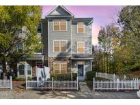 Charming two-story townhome with a white picket fence and well-maintained landscaping at 11700 Coppergate Dr # 100, Raleigh, NC 27614