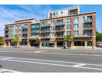 Beautiful mixed-use building featuring brick, beige concrete and black iron balconies at 140 W Franklin St # 706, Chapel Hill, NC 27516