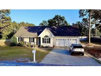 Charming single-Gathering home with a well-maintained lawn, two-car garage, and covered porch at 15 Colonial Hills Dr, Lillington, NC 27546