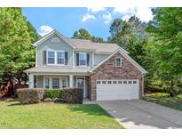 Charming two-story home with a stone accent, well-manicured lawn, and attached two-car garage at 1608 Hayesville Dr, Fuquay Varina, NC 27526