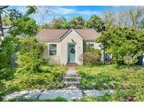 Charming bungalow featuring a quaint front entrance, complemented by lush green surroundings at 214 Northwood Cir, Durham, NC 27701