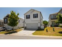 Charming two-story home with a two-car garage and a well-manicured lawn at 33 White Ash Dr, Clayton, NC 27527