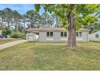 Charming home featuring a well-maintained front yard and a convenient carport at 3312 Apache Dr, Raleigh, NC 27609