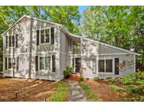 Two-story home with a modern design and lush landscaping in a serene wooded setting at 568 Piney Mountain Rd, Chapel Hill, NC 27514