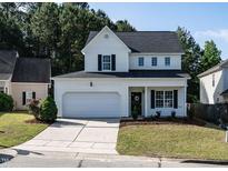 Charming two-story home features a two-car garage, welcoming front porch, and beautifully landscaped front yard at 637 Prickly Pear Dr, Fuquay Varina, NC 27526