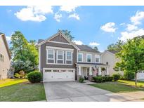 Charming two-story home boasts manicured lawn and a two-car garage at 846 Lake Artesia Ln, Fuquay Varina, NC 27526