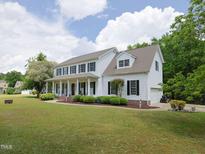 Charming two-story home with manicured lawn, covered porch, and attached garage at 101 Cardinal Dr, Youngsville, NC 27596