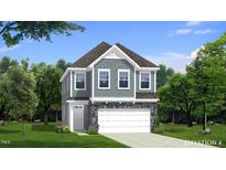 Charming two-story home featuring gray siding, stone accents, and a welcoming front entrance at 1024 Channel Drop, Zebulon, NC 27597