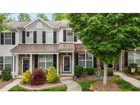 Charming townhome featuring a well-manicured front yard and a welcoming entrance at 1096 Kelso Ln # 18, Burlington, NC 27215