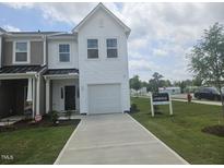 Charming two-story townhome with a one-car garage and well-manicured front lawn at 12 Lavender Ln, Clayton, NC 27520